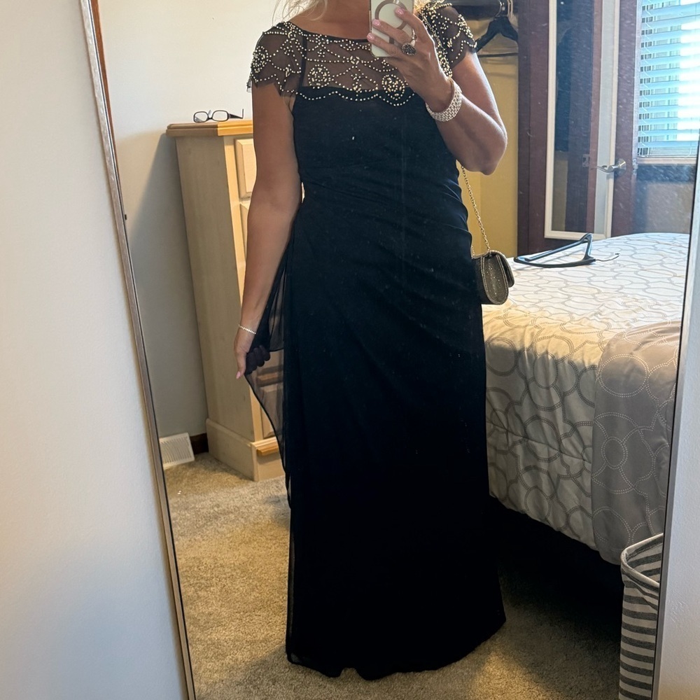 Xscape Beaded Yoke Cap Sleeve Round Neck Ruched Cascade Ruffle
Side Gown - Picture 4 of 12